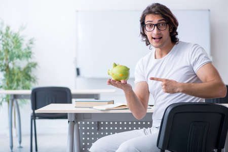 Young male student in front of whiteboardの写真素材
