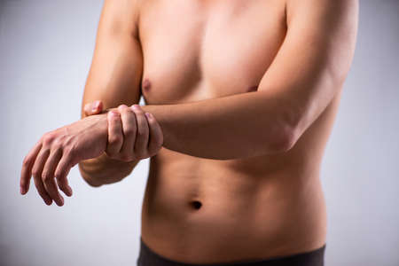 Young man suffering from upper limb painの写真素材