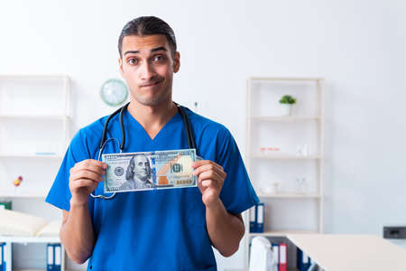 Young male doctor working in the clinicの写真素材
