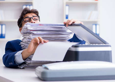 The businessman making copies in copying machine