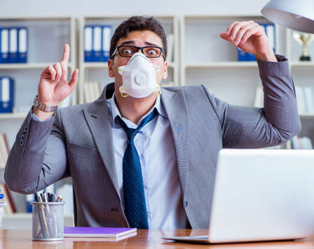 Businessman sweating excessively smelling bad in office at workplaceの写真素材