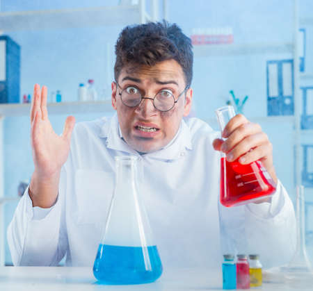 Funny mad chemist working in a laboratoryの写真素材