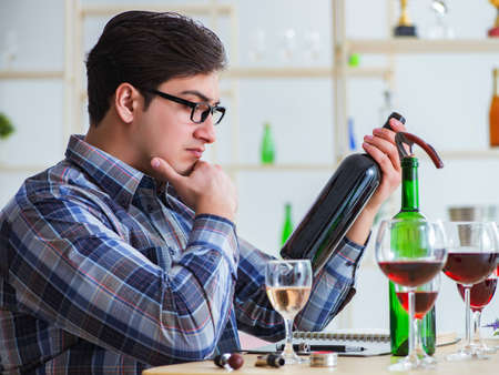 Professional sommelier tasting red wineの写真素材