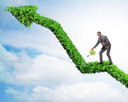 The businessman in investment concept watering financial lineの写真素材