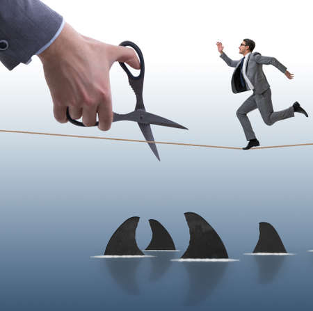 Hand cutting rope in business risk concept