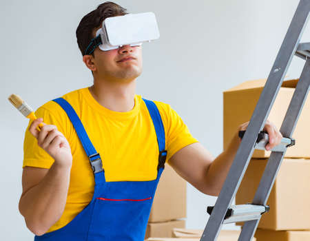 Painter contractor working with virtual reality goggles