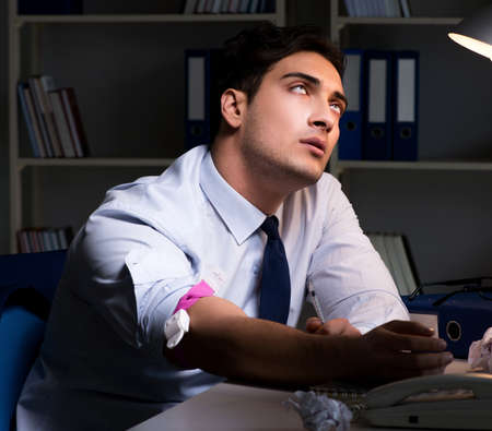 The employee relieving stress from overtime with drugs narcoticsの写真素材