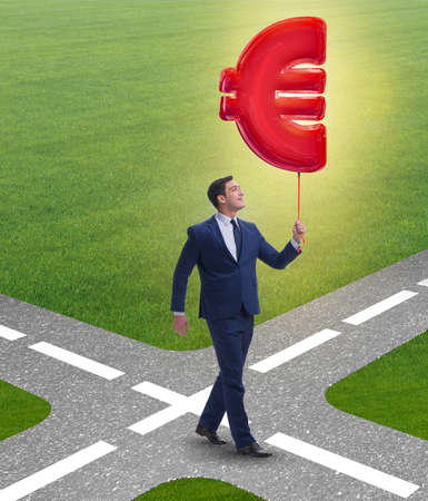 The businessman walking with inflatable euro signの写真素材