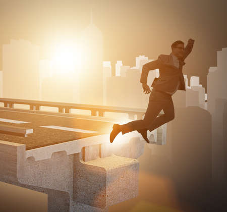 Businessman in uncertainty concept with broken bridgeの写真素材