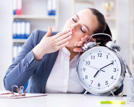 Businesswoman in time management concept sleepingの写真素材