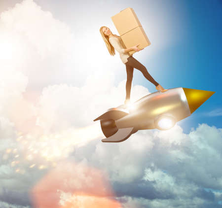 Woman in fast box delivery service on rocketの写真素材