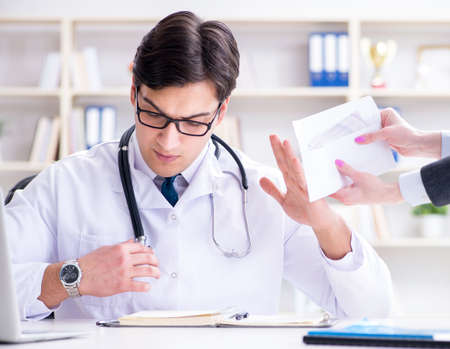 Young doctor in medical insurance fraud conceptの写真素材