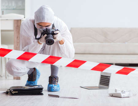 Forensic expert at crime scene doing investigationの写真素材