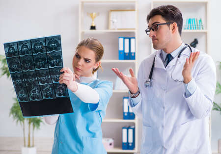 The two doctors examining x-ray images of patient for diagnosisの写真素材