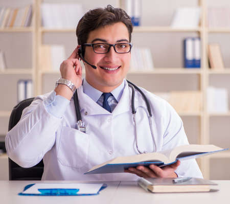 Young man doctor in medical conceptの写真素材