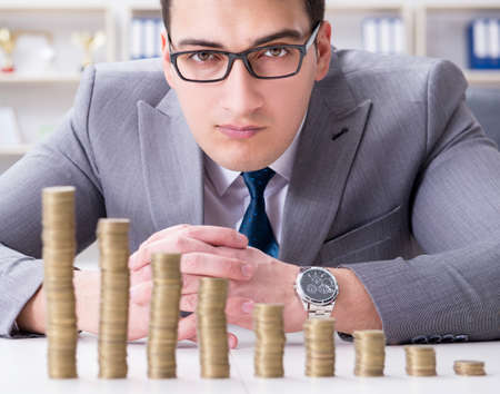 Businessman with golden coins in business growth conceptの写真素材