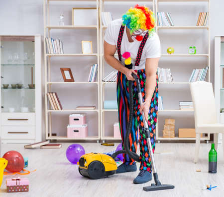 Funny clown doing cleaning at homeの写真素材
