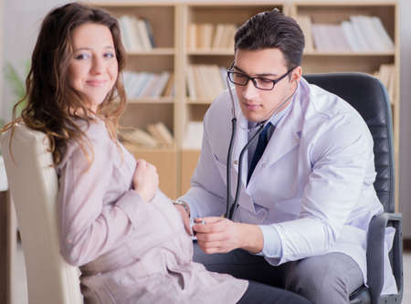 Pregnant woman visiting doctor for consultationの写真素材