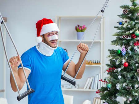 Injured man celebrating christmas at homeの写真素材