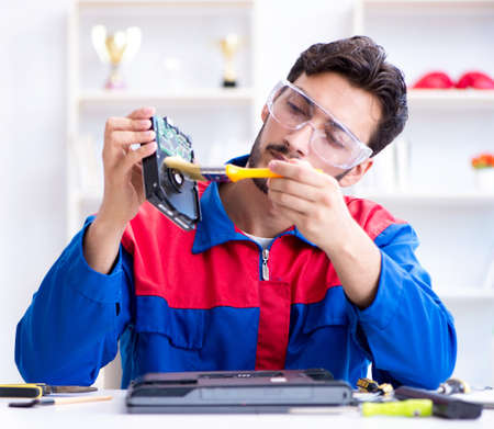 Repairman working in technical support fixing computer laptopの写真素材