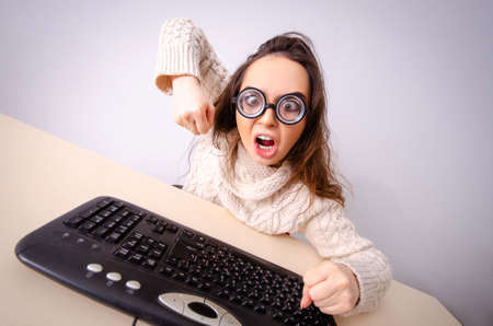 Funny nerd girl working on computer
