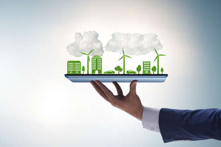 The hand holding tablet with mini ecosystem and clean energyの写真素材