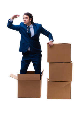 Young male employee with boxes isolated on whiteの写真素材