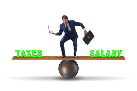 Businessman balancing between taxes and salaryの写真素材