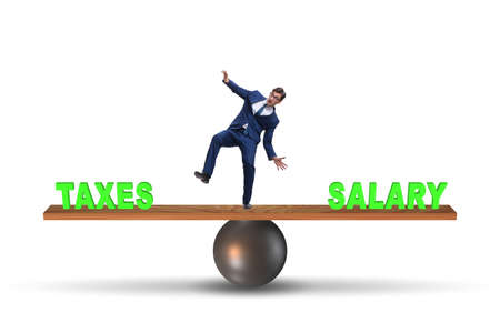 Businessman balancing between taxes and salaryの写真素材