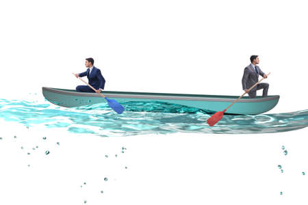 Disagreement concept with businessmen rowing in different directの写真素材