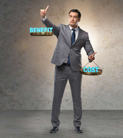 Businessman in cost benefit balance conceptの写真素材