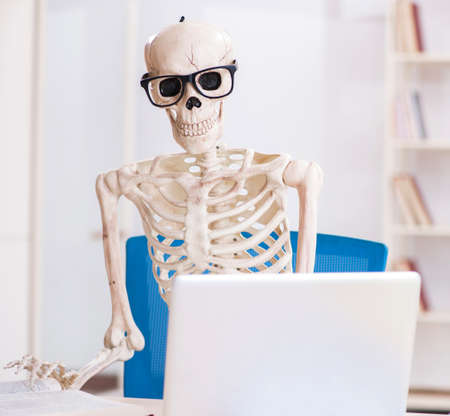 Skeleton businessman working in the office
