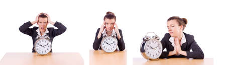 Businesswoman with clock missing her deadlinesの写真素材