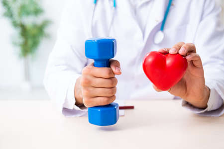 Young male doctor in sport and dieting conceptの写真素材