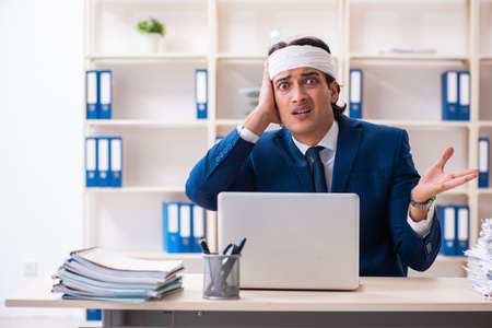 Head injured male employee working in the officeの写真素材
