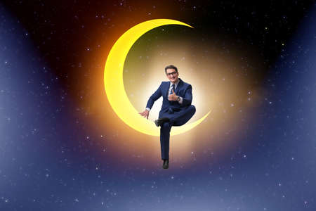 Businessman sitting on the crescent moon