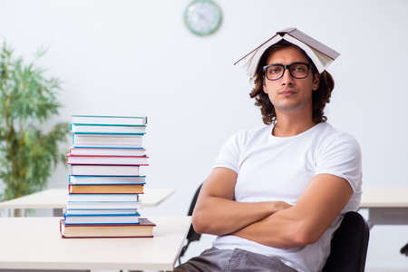 Young male student sitting in the classroomの写真素材