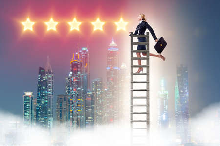 Businesswoman reaching out for stars in success conceptの写真素材