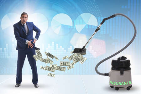 Businessman and vacuum cleaner sucking money out of himの写真素材