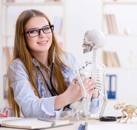 Student sitting in classroom and studying skeleton