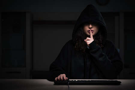 Female hacker hacking security firewall late in office