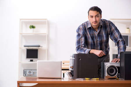 Young engineer repairing musical hi-fi system