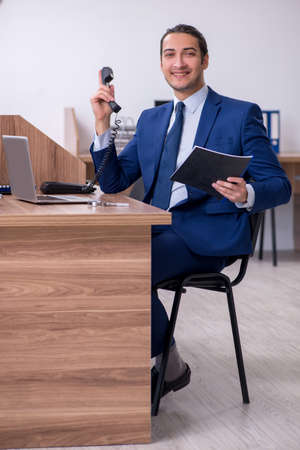 Young handsome businessman working in the officeの写真素材