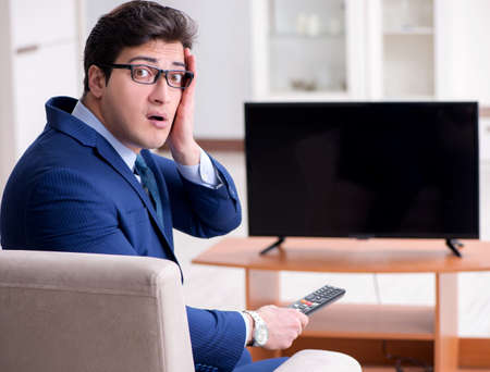 Businessman watching tv in the officeの写真素材