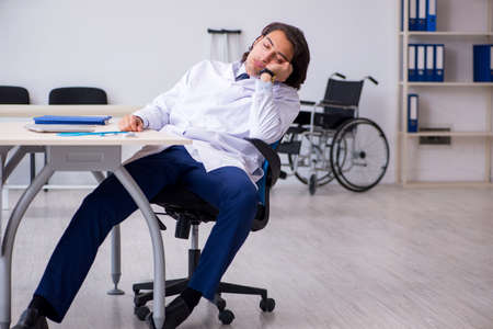 Young doctor being tired after night shiftの写真素材