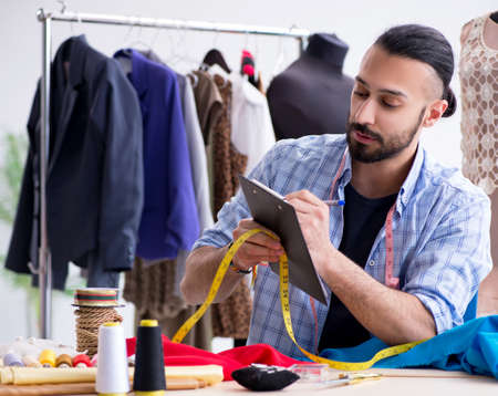 Male tailor working in the workshop on new designsの写真素材