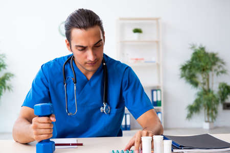 Young male doctor in sport and dieting concept