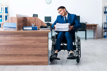 Young male employee in wheel-chair