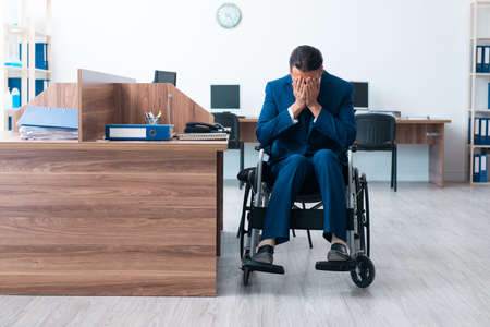 Young male employee in wheel-chairの写真素材