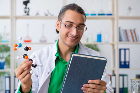 Young male chemist teacher in the lab